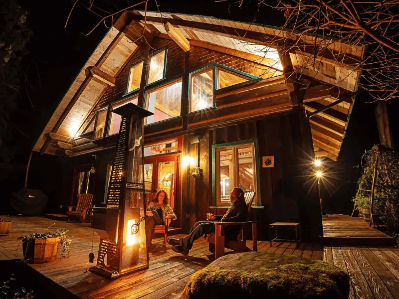 Patio heater on the deck of a cabin with two people in front of it